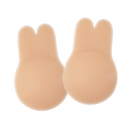 Pair of nude-colored Boob Bunnies breast lift pads with a bunny-ear shaped top and rounded base, made from smooth silicone material. Displayed on a transparent background with a subtle shine highlighting their soft, skin-like texture.